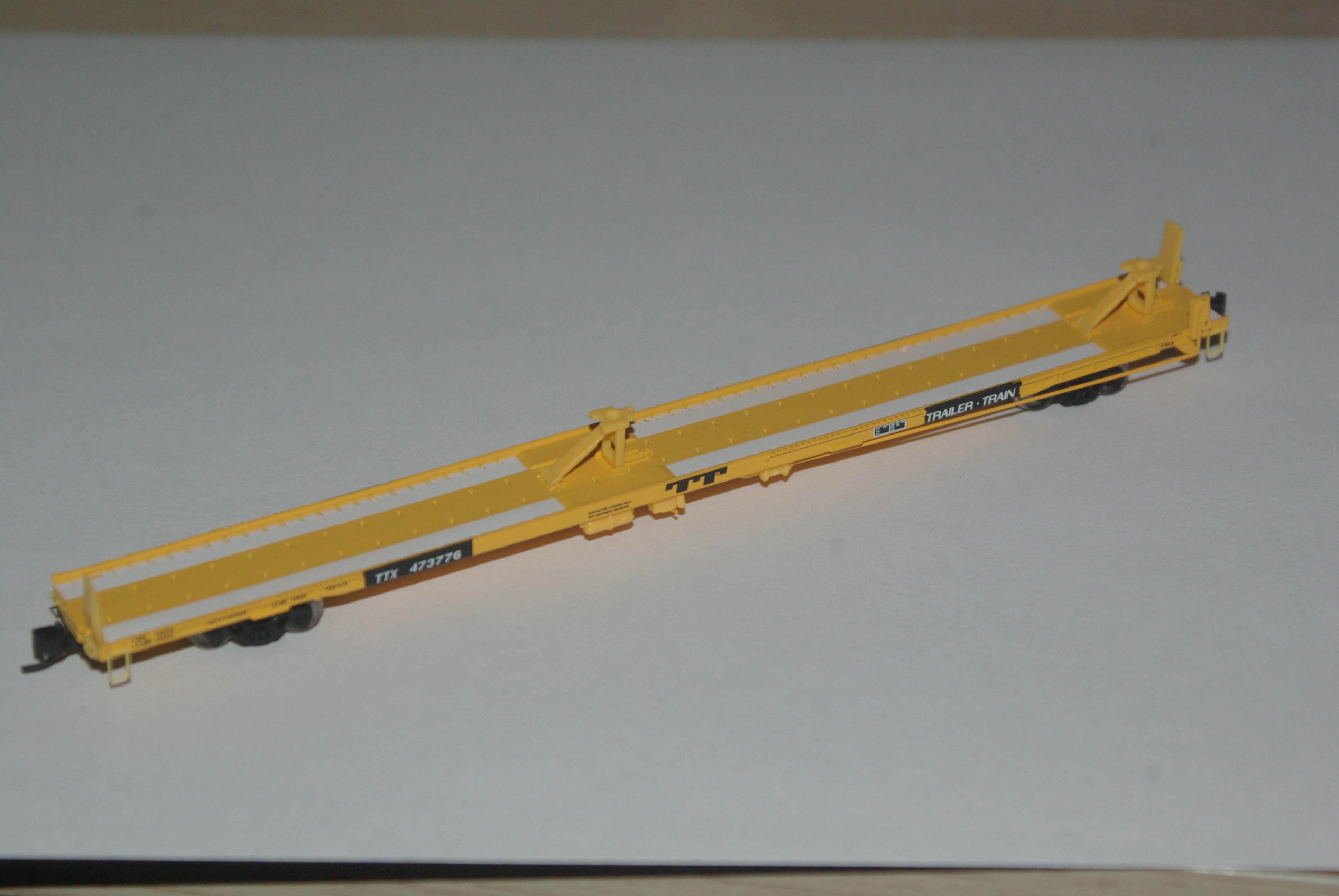 Trainworx 85ft pullman standard flatcar in Trailer Train Yellow paint.